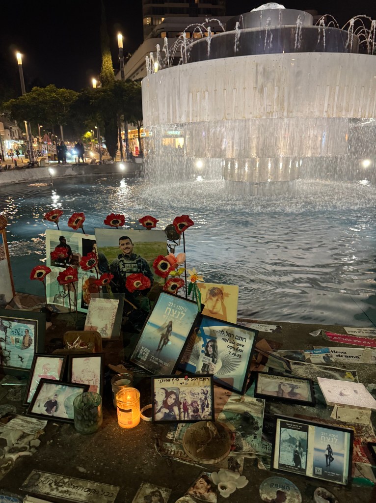 Memorial photos at a roundabout in Tel Aviv near Hostage Square.